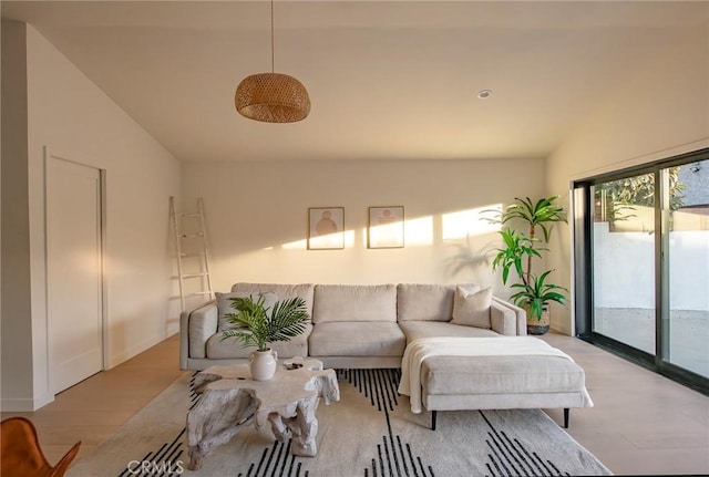 living room with lofted ceiling and light wood-type flooring