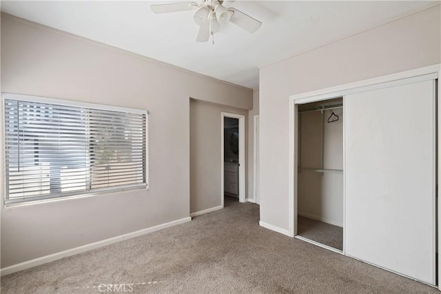 unfurnished bedroom featuring carpet floors, ceiling fan, baseboards, and a closet