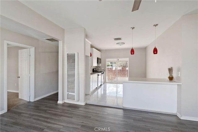 kitchen featuring visible vents, white cabinets, and dark wood finished floors