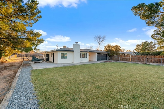 rear view of house with a patio and a lawn