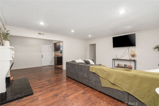 living room with dark wood-type flooring and ornamental molding