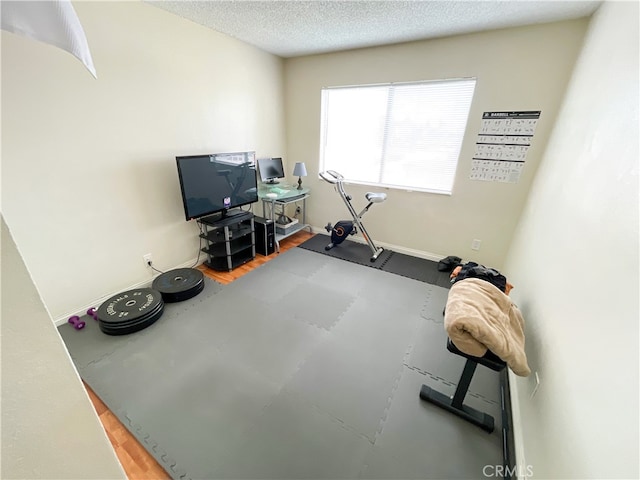 exercise room featuring a textured ceiling