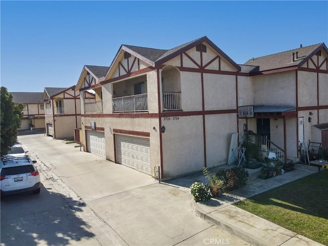 view of front of property with a garage and a balcony