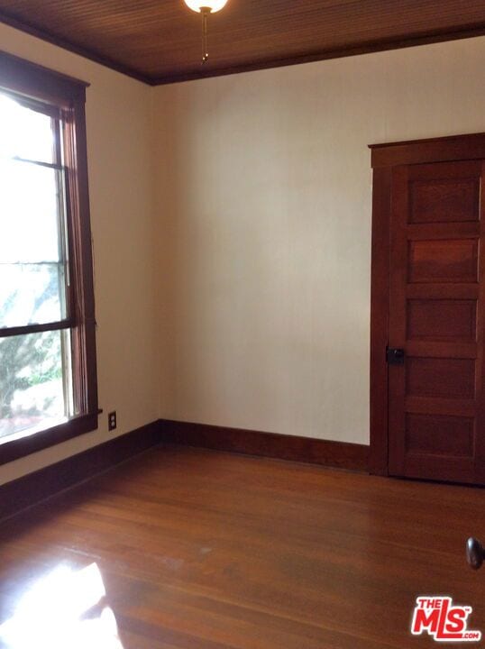 empty room with hardwood / wood-style floors and wood ceiling