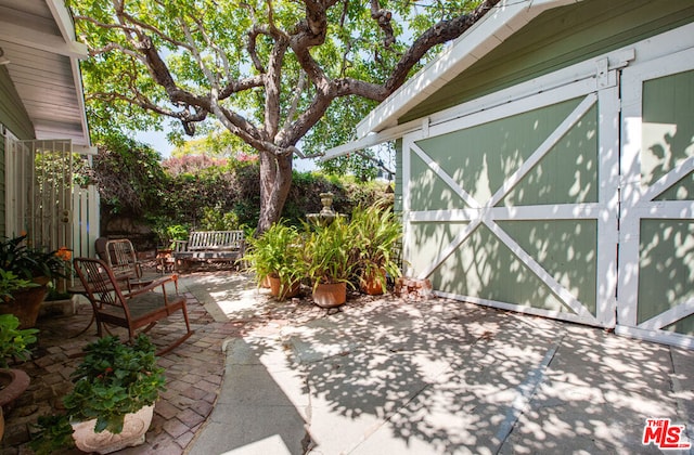 view of patio / terrace featuring a storage shed