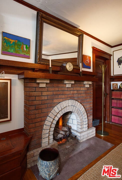 interior details with hardwood / wood-style flooring and crown molding