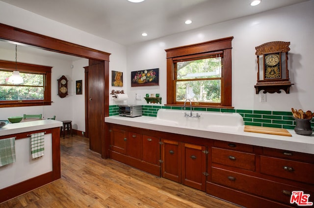 bathroom with hardwood / wood-style flooring, plenty of natural light, and sink