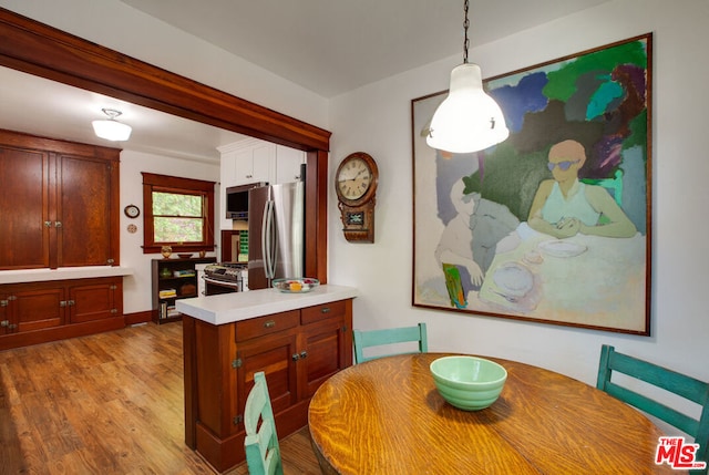 dining space with light hardwood / wood-style flooring