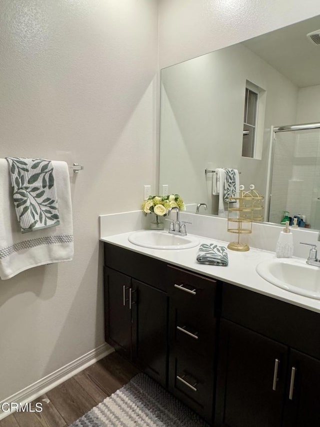 bathroom with vanity, hardwood / wood-style floors, and walk in shower