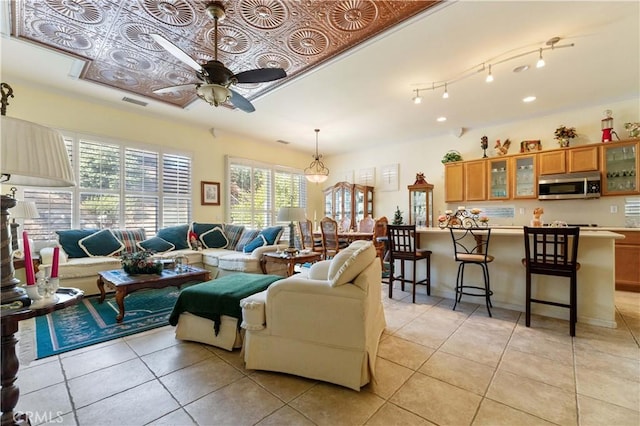 tiled living room featuring ceiling fan