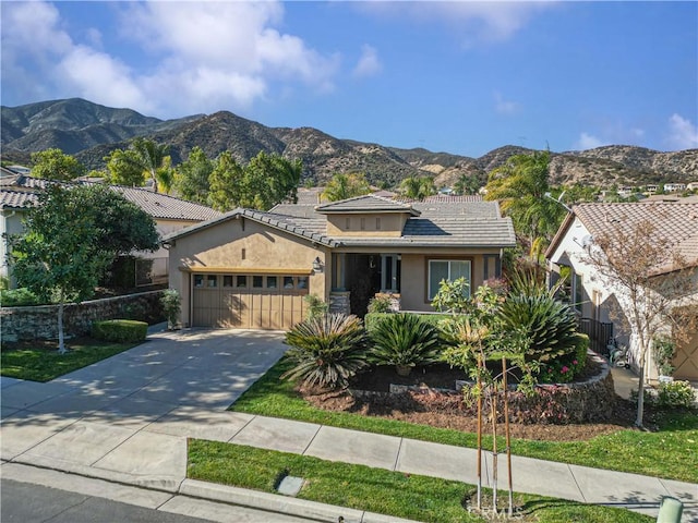 view of front of house featuring a garage and a mountain view