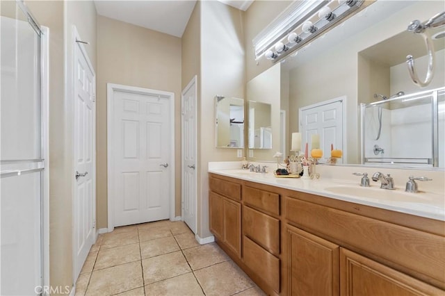 bathroom featuring tile patterned flooring, vanity, and a shower with shower door