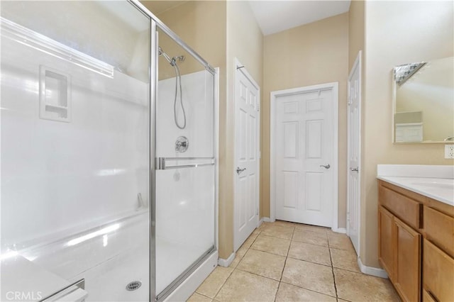 bathroom with tile patterned floors, an enclosed shower, and vanity