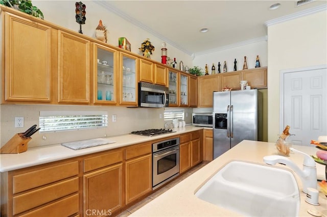 kitchen featuring ornamental molding, appliances with stainless steel finishes, and sink