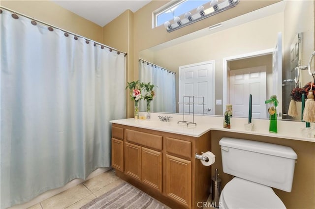 bathroom featuring vanity, toilet, and tile patterned flooring