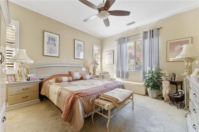 carpeted bedroom featuring ceiling fan and ornamental molding