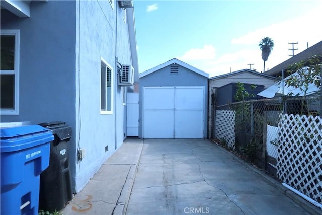 exterior space featuring a garage and an outbuilding