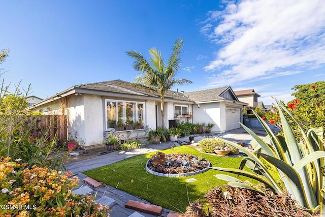 view of front of house with a garage and a front lawn