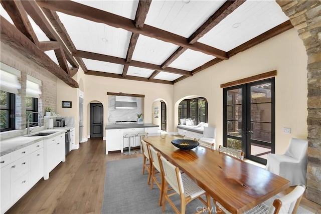 dining area with beamed ceiling, sink, dark hardwood / wood-style flooring, and french doors