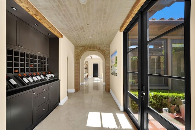 wine area featuring brick ceiling and brick wall