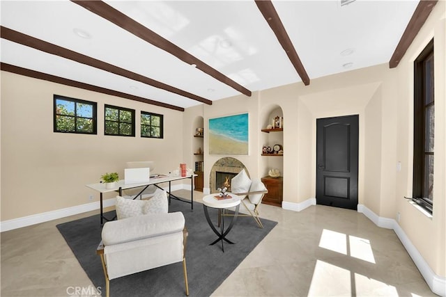 living area featuring built in shelves and beamed ceiling