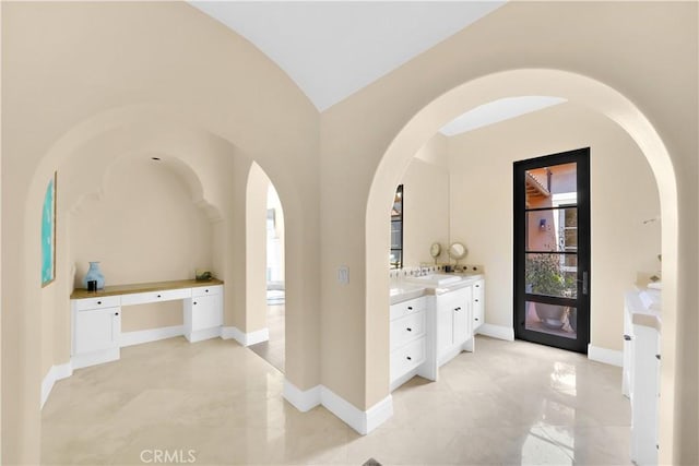 bathroom with vanity and vaulted ceiling