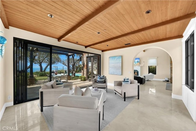 living room with beam ceiling, plenty of natural light, and wood ceiling