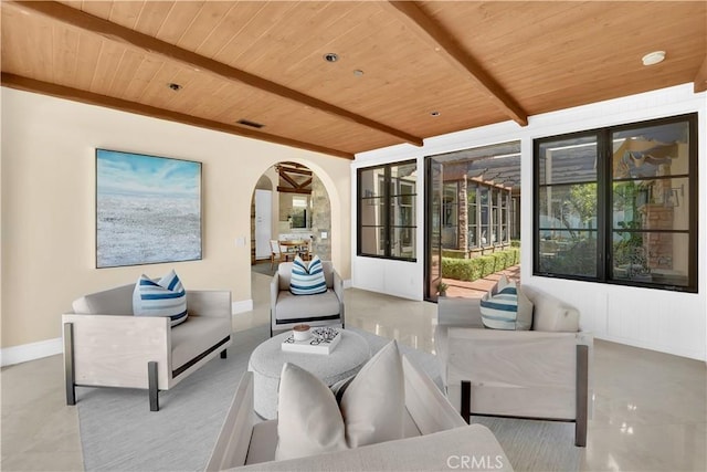 living room featuring beamed ceiling and wooden ceiling