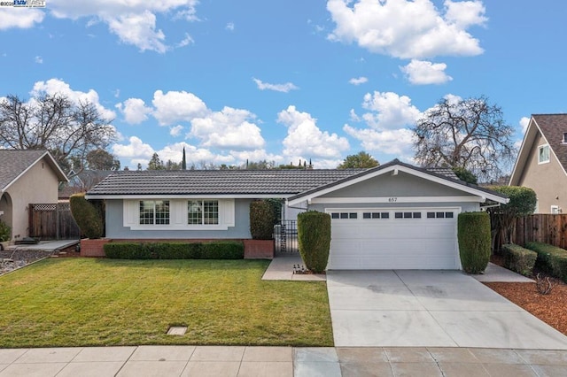 ranch-style house featuring a garage and a front lawn