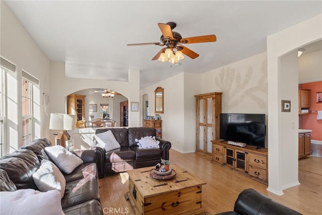 living room with ceiling fan and light hardwood / wood-style floors