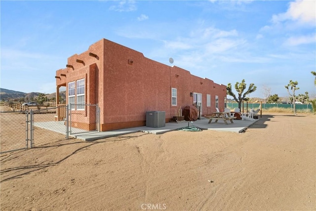 back of house featuring a patio and central air condition unit