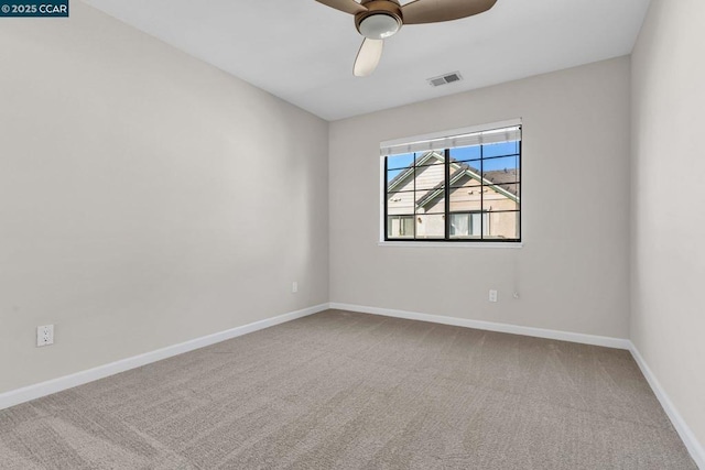 spare room featuring ceiling fan and carpet