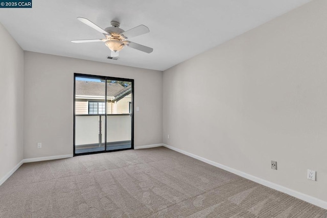 carpeted spare room with ceiling fan