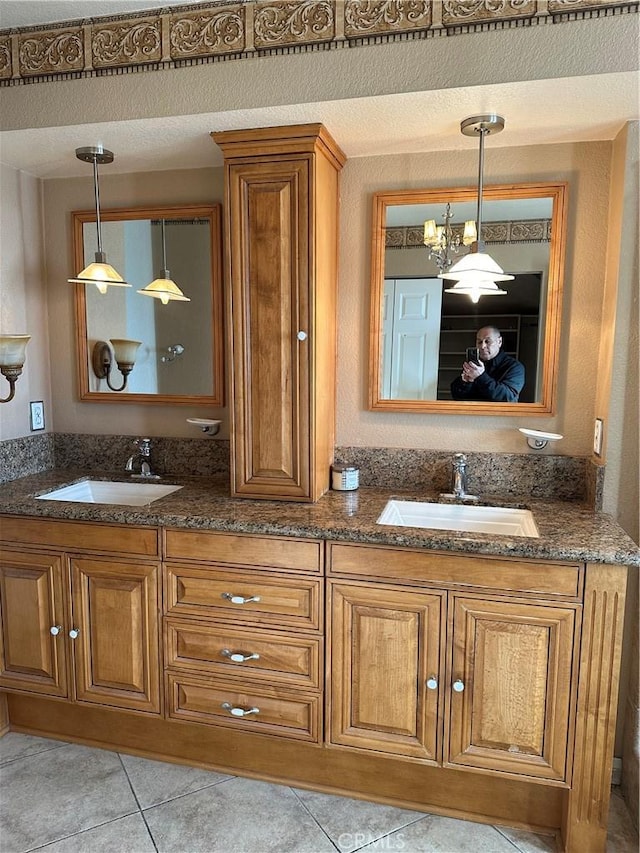 bathroom featuring vanity, tile patterned flooring, a textured ceiling, and an inviting chandelier