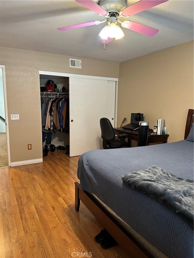 bedroom with ceiling fan and light hardwood / wood-style floors