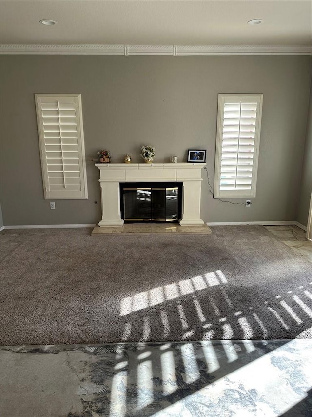 unfurnished living room featuring crown molding and a premium fireplace