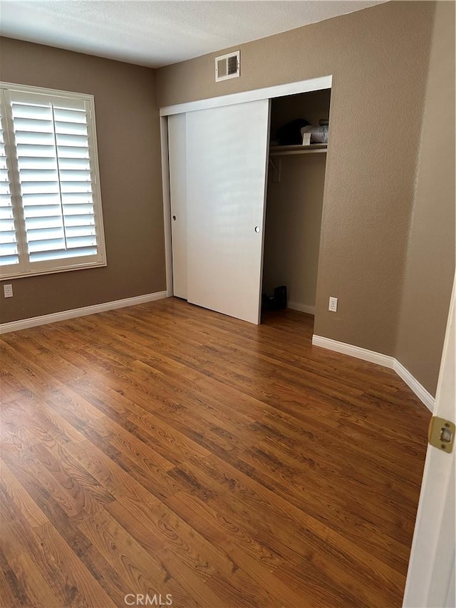 1310 Parsley Ln, Corona, CA 92879 - unfurnished bedroom with wood finished floors and a closet