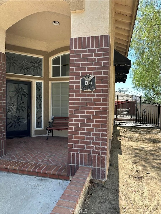 1310 Parsley Ln, Corona, CA 92879 - entrance to property with brick siding, stucco siding, and a gate