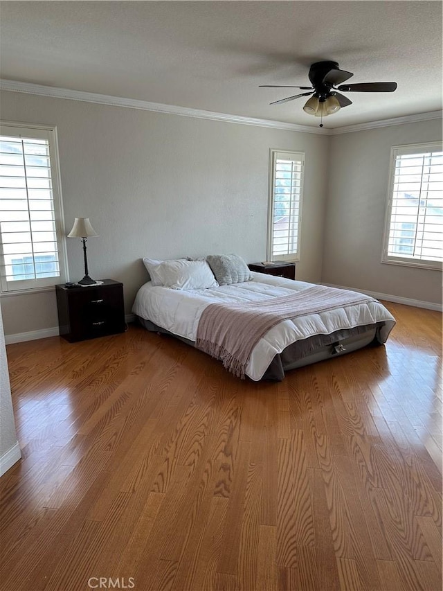 1310 Parsley Ln, Corona, CA 92879 - bedroom with multiple windows, wood finished floors, crown molding, and ceiling fan
