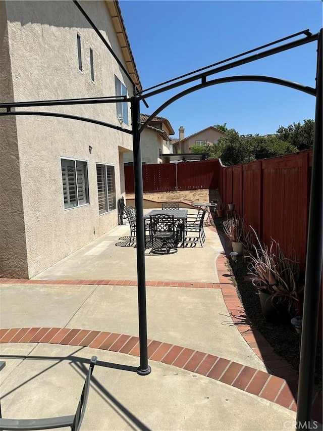 1310 Parsley Ln, Corona, CA 92879 - fenced backyard with a patio and outdoor dining space