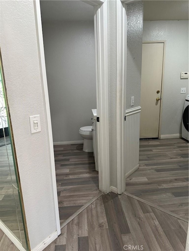 1310 Parsley Ln, Corona, CA 92879 - bathroom with wood finished floors, washer / clothes dryer, and a textured wall