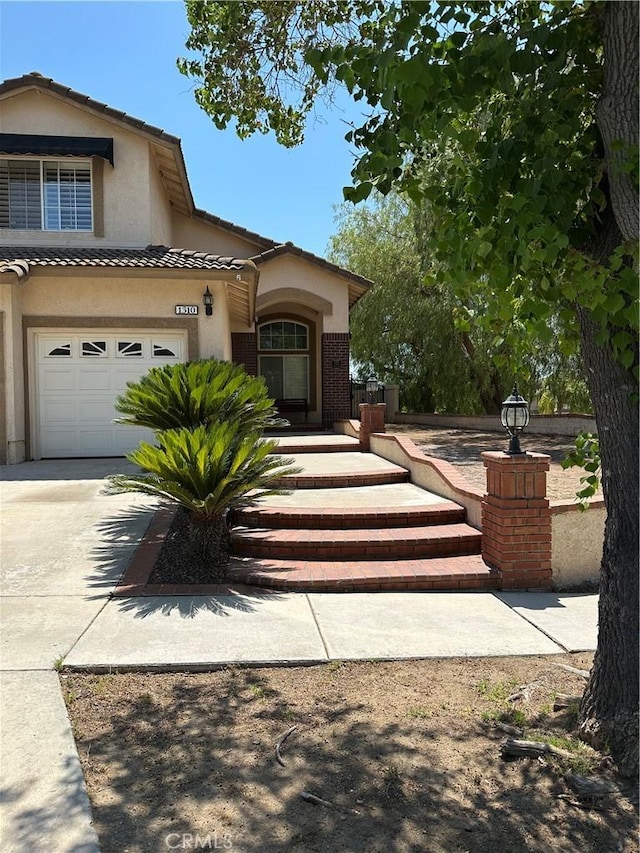 1310 Parsley Ln, Corona, CA 92879 - view of front of home featuring driveway, stucco siding, and a tile roof