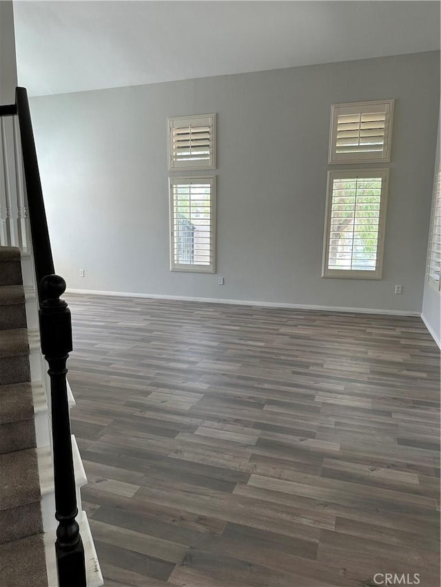 1310 Parsley Ln, Corona, CA 92879 - spare room featuring wood finished floors, stairway, and healthy amount of natural light