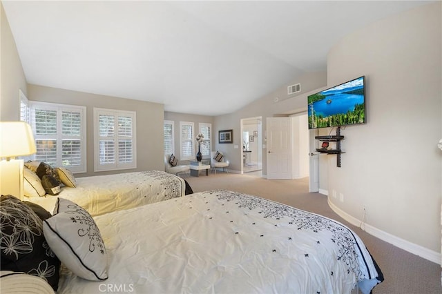 bedroom featuring multiple windows, carpet, and lofted ceiling