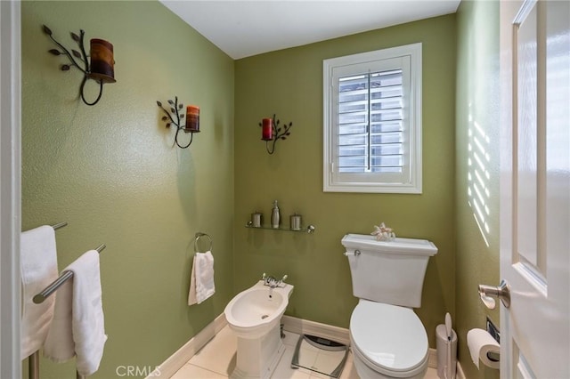 bathroom with tile patterned flooring, a bidet, and toilet