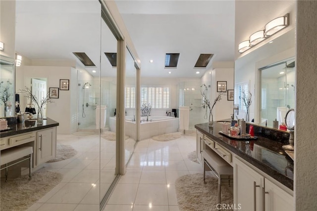 bathroom with vanity, tile patterned floors, and plus walk in shower