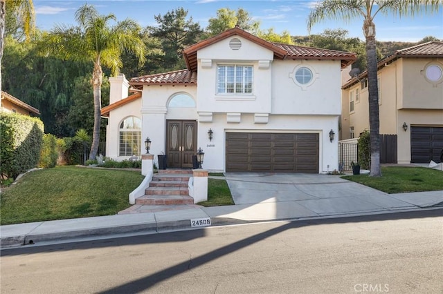 mediterranean / spanish-style house with a garage and a front lawn