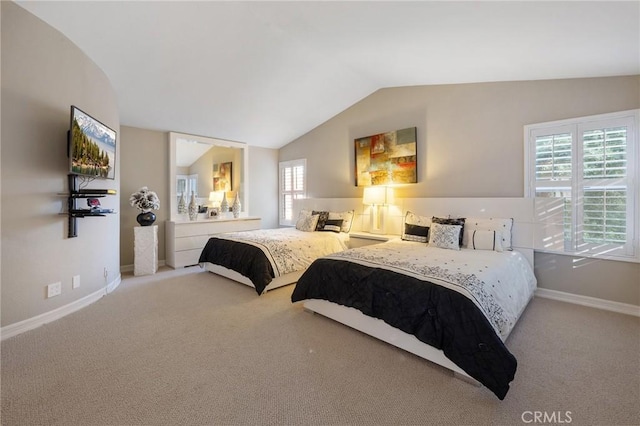 bedroom featuring carpet and lofted ceiling