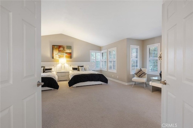 bedroom featuring carpet and lofted ceiling