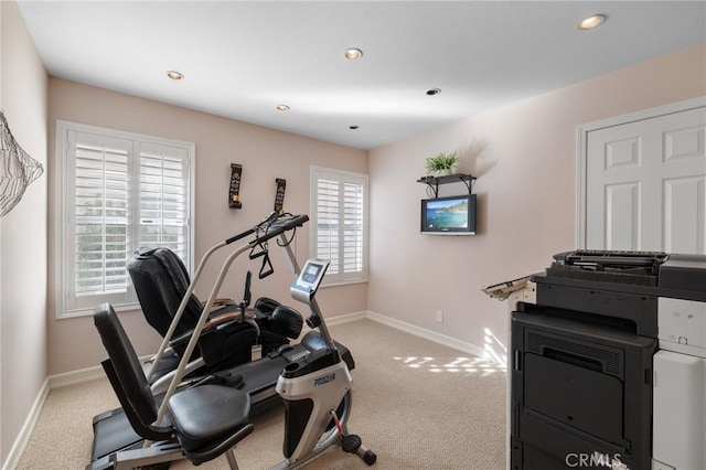 exercise room featuring light colored carpet